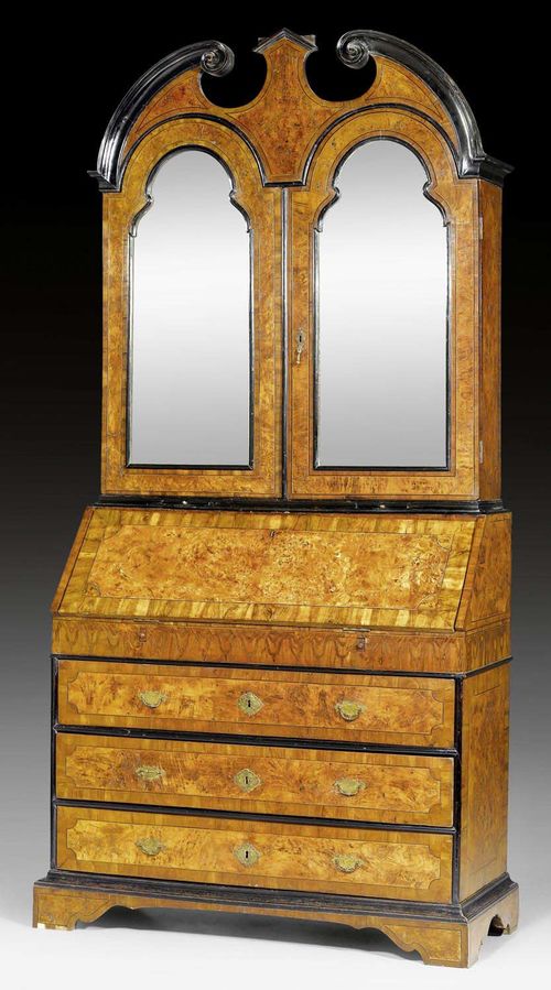 BUREAU CABINET, known as a "trumeau," Baroque, probably Lombardy circa 1720/30. Shaped and partly ebonized walnut burlwood and local fruitwoods with inlays. Front with fall-front writing surface above 3 drawers. Interior with large central compartment with inlays and free-standing corner columns flanked by drawers and compartments. Reset, mirrored upper section with double doors over 2 small pull-out shelves. Interior of upper section fitted with drawers and compartments. 3 secret compartments opened by pressing decorative volutes. Gilt bronze mounts. 116x47x(open 81)x245 cm.