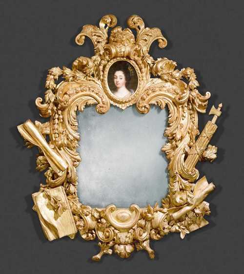 IMPORTANT GILTWOOD MIRROR WITH CARTOUCHES AND FASCES,Baroque, Rome  circa 1660. Pierced and finely carved giltwood frame with cartouche atop enclosing oval portrait of "Anna of Austria". H 165 cm, W 135 cm. Provenance: from a Paris private collection.