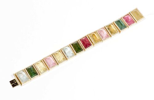 GEMSTONE AND DIAMOND BRACELET. Yellow gold 750. Very decorative bracelet of 14 rectangular links, each set with a rectangular gemstone cabochon, including green, yellow-green, petrol-blue and pink tourmaline, etc., of ca. 15 x 10 mm, each in a frame set with brilliant-cut diamonds. 430 brilliant-cut diamonds in total, weighing ca. 5.50 ct. L ca. 19.5 cm, W ca. 1.9 cm. One hinge needs repair. From the estate of Charlotte and Egon Karter-Sender, Basel.