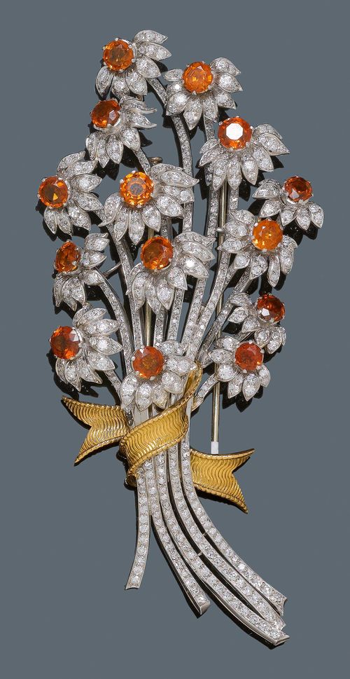 DIAMOND AND GARNET BROOCH, France, ca. 1940. Platinum and yellow gold. Elegant, decorative brooch designed as a large bouquet with a textured gold band, the centre of the 14 flowers each decorated with a hessonite, total hessonite weight ca. 10.00 ct, petals and stem are set throughout with brilliant-cut diamonds and single-cut diamonds weighing ca. 5.50 ct. H ca. 11.3 cm.