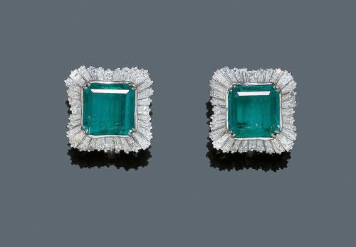 EMERALD AND DIAMOND EAR CLIPS, ca. 1950. White gold 750. Very elegant ear clips with studs, set with 2 octagonal, Columbian emeralds weighing ca. 7.00 ct and of fine colour, slightly oiled, each within a border of 42 baguette-cut diamonds, total weight of the diamonds ca. 3.50 ct. With Gemlab Report No. 2182/09. From the heirs of Baron Anton Kiss (1880-1970), son of Katharina Schratt, Schloss Mondsee.