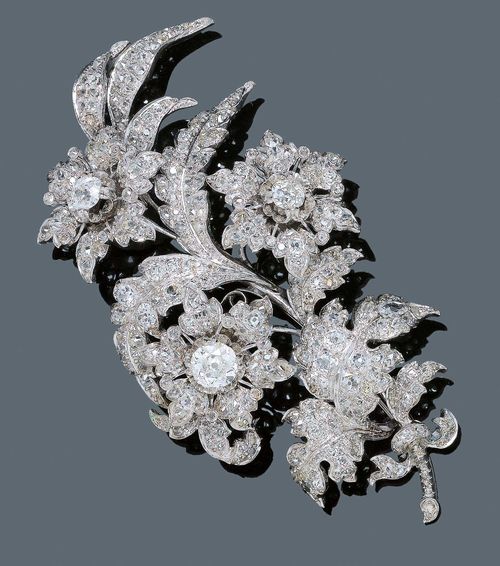 DIAMOND BROOCH, ca. 1880. Silver over yellow gold, rhodinized. Attractive, large brooch designed as a flowering branch with three blossoms, the centre of  each blossom decorated with a diamond of ca. 1.80 ct, 0.60 ct and 0.95 ct, respectively. Blossoms, leaves and stems are additionally set throughout with 344 diamonds weighing ca. 13.00 ct. Restored. Mechanical part and rhodium-plating, not original.