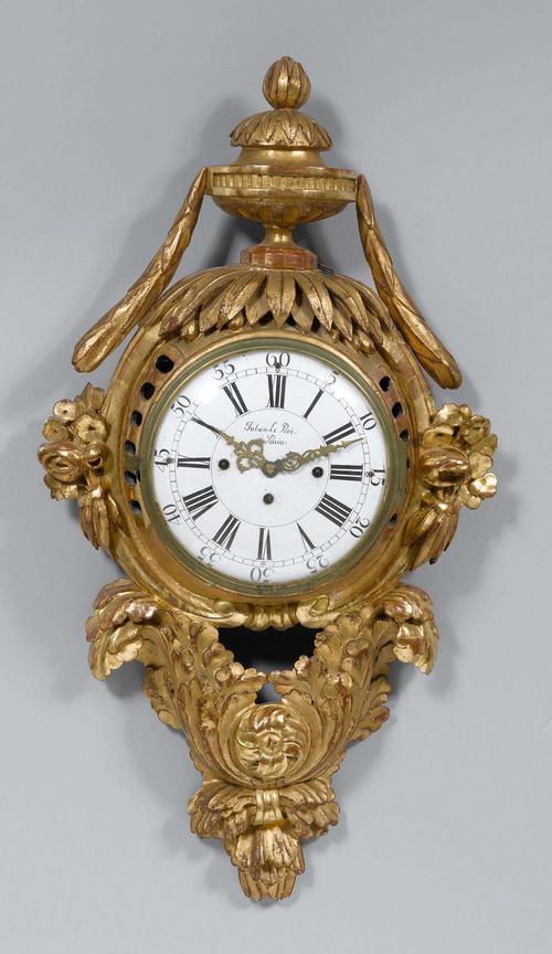 CARTEL CLOCK,Louis XVI, France. Wood, carved and gilt. Cartouche-shaped case. White enamel dial. The work removed. H 83 cm.