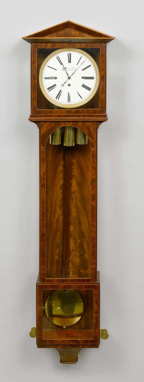 DACHL CLOCK,Biedermeier, Vienna. The dial signed "MERZ & SOHN WIEN STEPHANSPLATZ NO 5". Mahogany. White enamel dial in a gilt bronze lunette. Fine movement with anchor escapement and 1/4-hour strike on 2 gongs. Repetition on demand. H 144 cm.