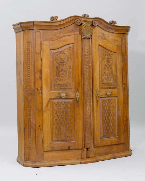 CARVED AND INLAID CUPBOARD, Bregenz Forest, circa 1800. Cherry. Later medallion bearing the date 1796. Interior with 3 drawers. Brass mounts. 1 door handle incomplete. 160x51x183 cm. Missing elements, cornice incomplete.
