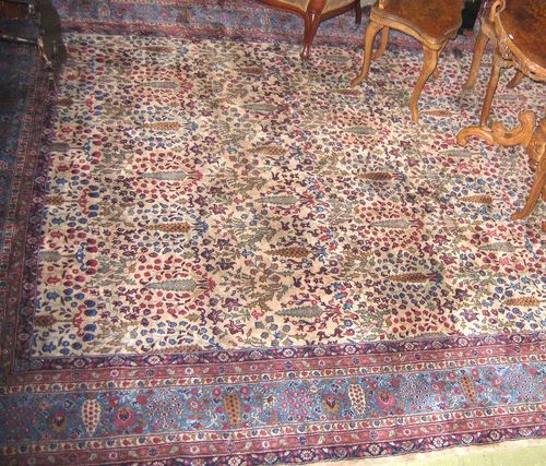 INDO TABRIZ old.Beige central field entirely patterned with trees and flowers in delicate pastel colours, blue edging, good condition, 415x300 cm.