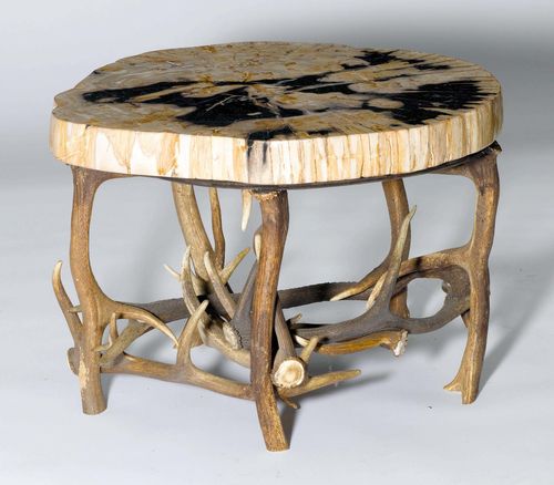 COFFEE TABLE,in the rustic style. Leaf, part of a petrified wood stump, on antler legs. 72x66x49 cm.
