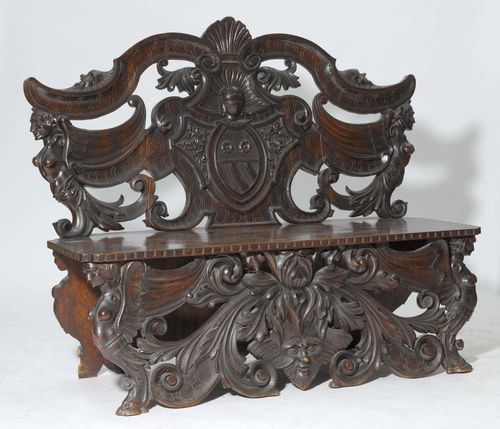 CARVED BENCH,Renaissance style, Italy. Richly carved walnut, stained. Rectangular seat. Curved backrest. L 150 cm. 1 rear leg defective.