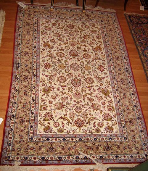 ISFAHAN old.White central field entirely patterned with trailing flowers and palmettes in harmonious colours, beige border, good condition, 225x150 cm.