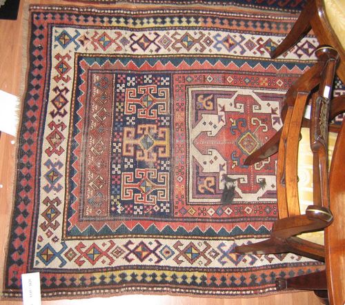 KAZAK antique.Central field with three square medallions, geometrically patterned with crosses and stars, white edging, strong signs of wear, 315x120 cm.