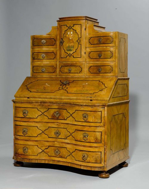 TABERNACLE WRITING DESK,Baroque, Germany or Austria, 18th century. Walnut, bone and other inlaid woods, in part stained. The top with 7 drawers and a door, the centre part with a foldable writing surface and 8 drawers. Lower part with three drawers. Brass mounts. 119x74(94)x174 cm. 4 keys. Requires some restoration.