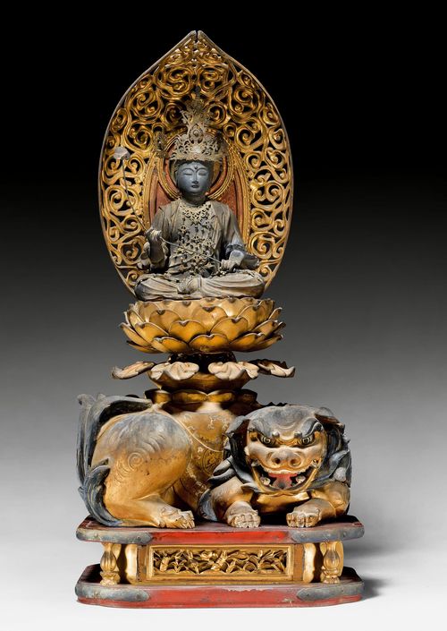 A WOOD AND GOLD LACQUER MONJU ON A LION. Japan, Edo period, height 53 cm. Minor damages. Possibly married.