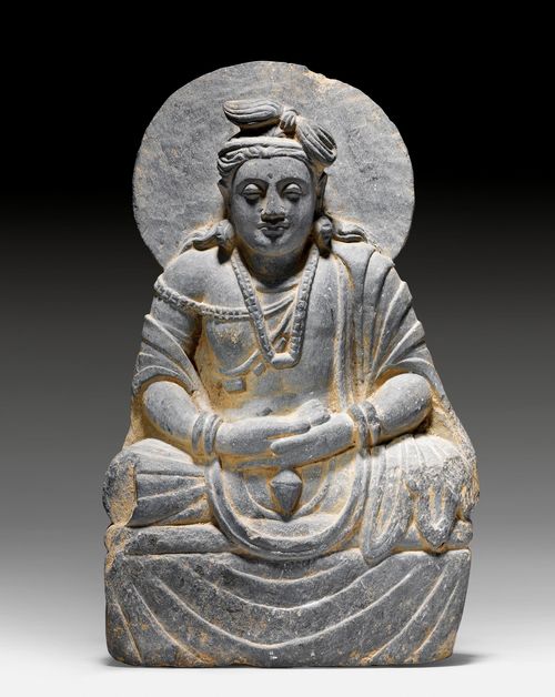 A GREY SCHIST FIGURE OF A SEATED BODHISATTVA WITH KALASHA. Gandhara, 2nd/3rd c. Height 36.5 cm.
