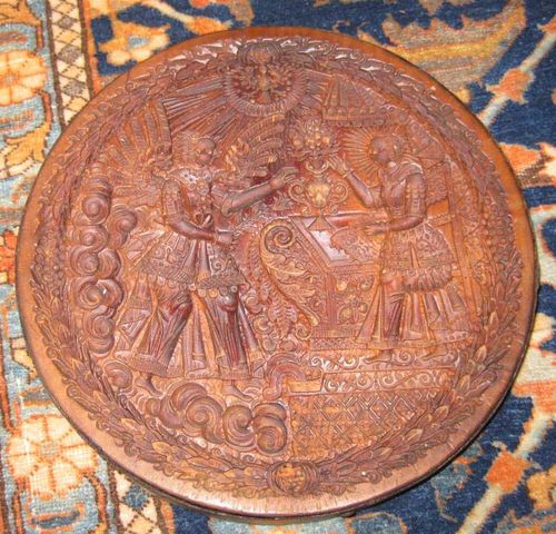 ROUND "TIRGGEL" BAKING MOULD,Switzerland, 17th/18th century. Carved wood depicting the Annunciation of Mary. Edge reinforced with iron band. D 24.5 cm.
