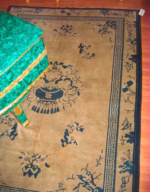 CHINA antique.Beige ground with a central medallion in the shape of a vase, the entire carpet is decorated with flowers and trees, beige border, signs of wear, 265x190 cm.