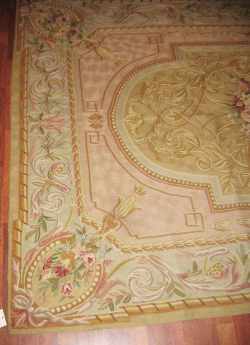 LOTZWILER old.Pink central field with a light green central medallion, the entire carpet is finely patterned with flower garlands in delicate pastel colours, light green border, good condition, 260x180 cm.