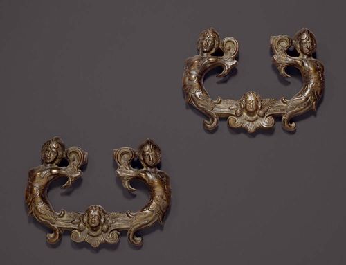 PAIR OF DOOR KNOCKERS,Renaissance, Northern Italy circa 1600. Burnished bronze. With mask and female figures. Mounted on plexiglass plaque. W 24 cm. Provenance: Private collection, Lugano.