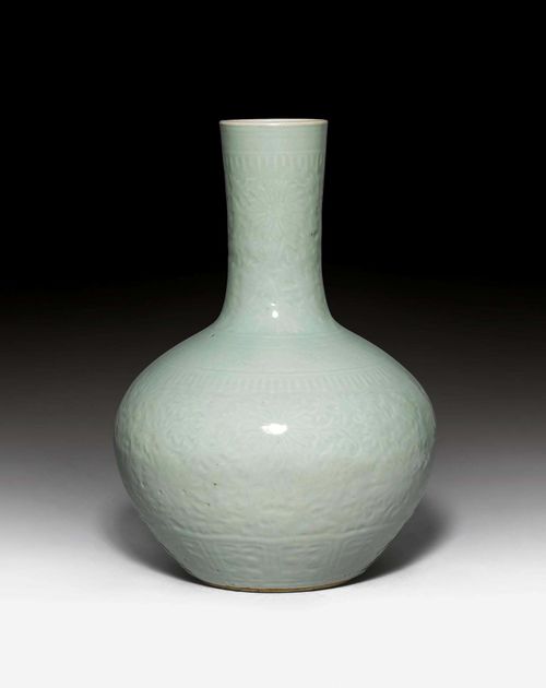 LARGE CELADON VASE. China, late Qing Dynasty, H 55 cm. Spheroid vase with a long, cylindrical neck. Incised lotus scroll design under the glaze. Apocryphal Qianlong mark.