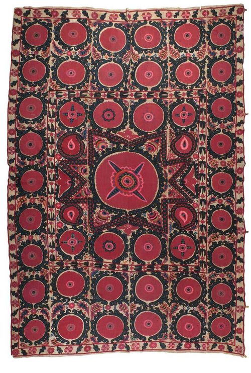 SUZANI BOCHARA, antique.Beige ground with a star-shaped central medallion, the entire carpet is patterned with stylized flowers in pink and green, signs of wear, 320x210 cm.