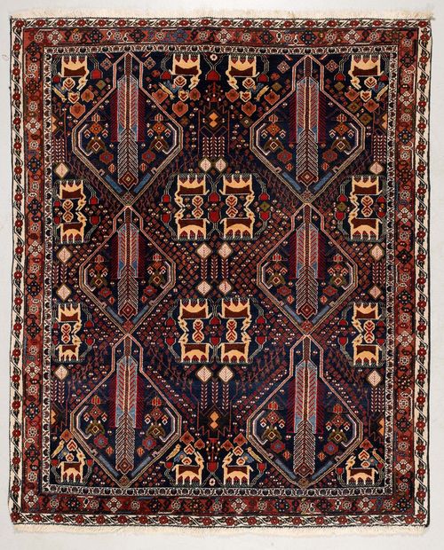 AFSHAR old.Dark blue central field geometrically patterned with plants and animals, narrow border in pink and white, good condition, 150x182 cm.