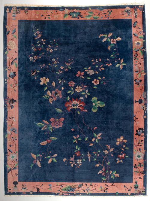 CHINA old.Blue ground, patterned throughout with flower motifs, pink border, signs of wear, 270x350 cm.