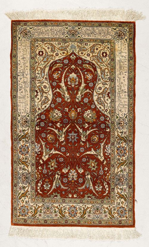 HEREKE PRAYER, old.Red mihrab with white spandrels, patterned with trailing flowers and palmettes, white border, slight wear, 74x123 cm.