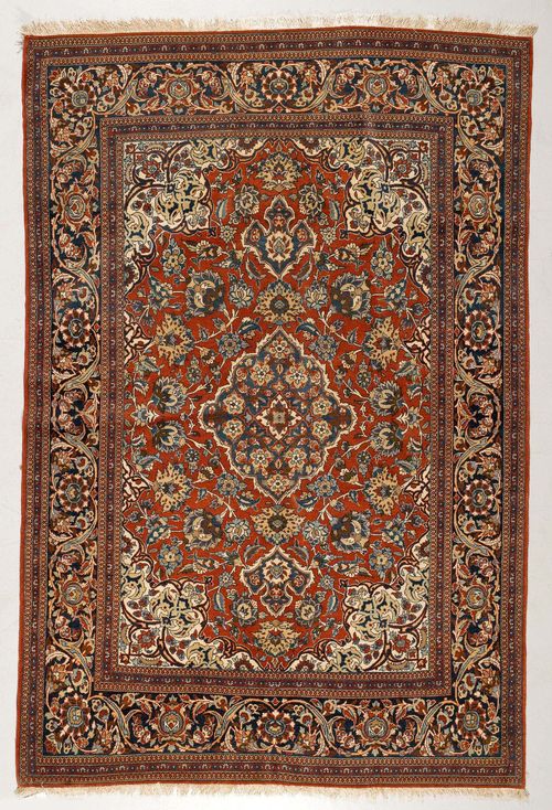 KESHAN old.Red ground with a blue central medallion and white corner motifs, patterned with blossoms and palmettes, blue trim, good condition, 136x208 cm.