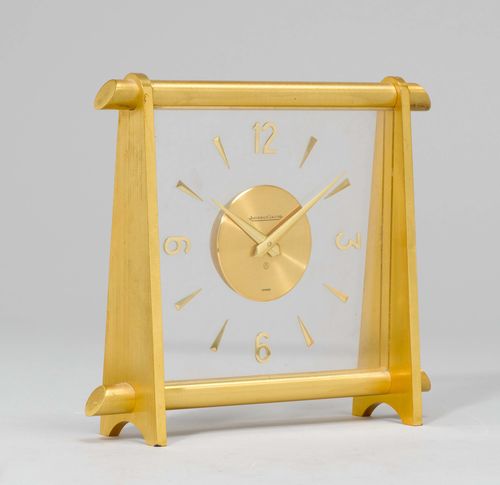 TABLE CLOCK, Jaeger le Coultre, 20th century. Brass and glass. Rectangular glass fronton with inserted dial. Brass supports. Movement with spring winding mechanism. H 18 cm.