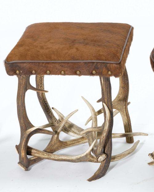 ANTLER STOOL, in the rustic style. Square, cushioned stool covered with brown cow hide, antler legs.