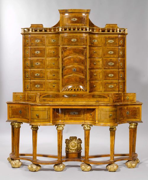 BAROQUE WRITING DESK, Germany, 18th century and later. Walnut and burlwood inlaid with light/dark fillets and parcel-gilt. Front with doors and 20 drawers. Centre part with writing surface, flanked by 2 drawers. Bronze and brass mounts. 167x65(80)x195 cm. 9 keys. Assorted. Provenance: Gut Aabach, Risch am Zugersee.