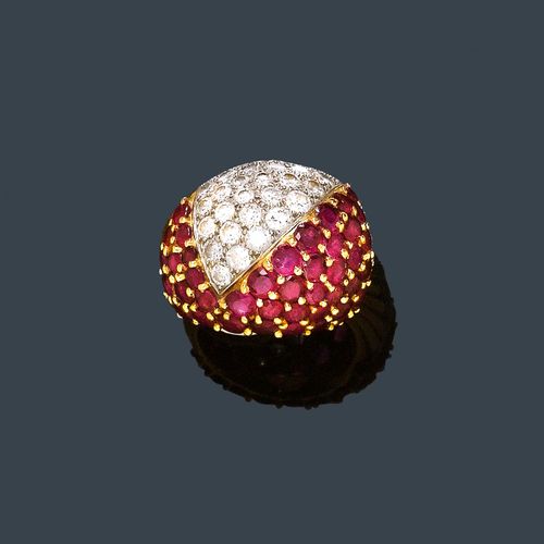 RUBY, DIAMOND AND GOLD RING, CARTIER, ca. 1950. Yellow and white gold 750. Decorative convex band ring, the top decorated with triangular motifs and set throughout with 42 rubies weighing ca. 2.00 ct and 42 brilliant-cut diamonds weighing ca. 1.50 ct. Signed Cartier Inc. 18Kts France, French export mark. Size ca. 50.