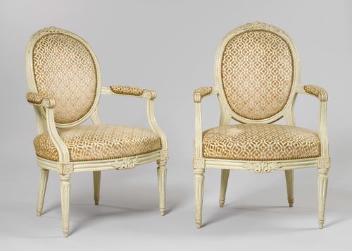 PAIR OF MEDALLION FAUTEUILS EN CABRIOLET, Louis XVI, Paris ca. 1780. Signed P. PLUVINET (Philippe-Joseph, maître as of 1754). Beech, carved laurel branches, rosettes, leaves and bow, and painted grey. Padded backrest. Polychrome patterned cover. Painting, in part later, some losses.