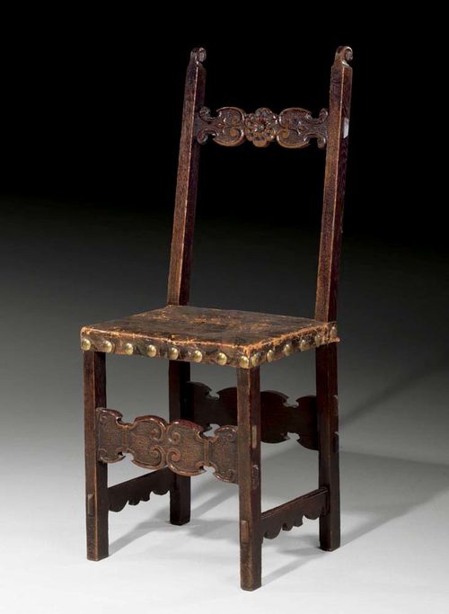 WALNUT CHAIR,early Baroque, Northern Italy, 18th century With stretcher, flat backrest with lateral scrolls and worn brown leather covers with decorative nail work. 45x37x52x112 cm. Provenance: Private collection Zurich.