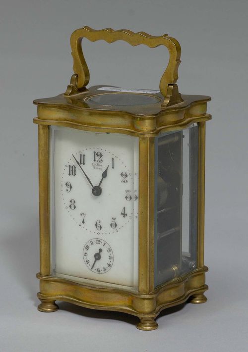 A TRAVEL ALARM CLOCK, France, 2nd half 19th century. The dial signed LE ROY REIMS. Brass. White enamel dial with chapter ring for time, beneath a smaller one for the alarm. Movement with spring winding, alarm on bell. H 13 cm.