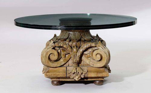 A SALON TABLE WITH GLASS TOP, Baroque style. Carved limewood, circular glass top. D 94, H 47 cm. Supplements in softwood.