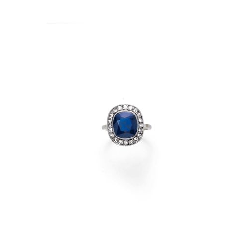 SAPPHIRE AND DIAMOND RING, ca. 1920. Platinum over yellow gold. Classic-elegant ring, the top set with 1 antique-oval sapphire weighing ca. 3.50 ct, within a border of 20 single-cut diamonds weighing ca. 0.40 ct. Size ca. 51.