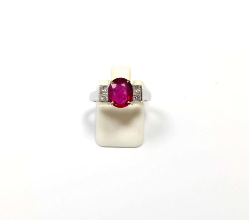 RUBY AND DIAMOND RING. White gold 750. Classic-elegant ring, set with 1 oval ruby weighing ca. 2.30 ct, flanked by 4 princess-cut diamonds weighing ca. 0.30 ct. Size ca. 54.
