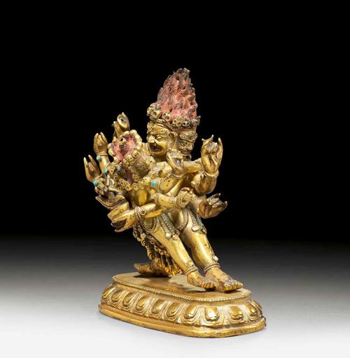 MANDALA GUARDIAN.Sino-Tibetan, 18th century H 10 cm. Gilt bronze, the hair painted in red. The arms decorated with small turquoises and glass stones. Very attractive quality.