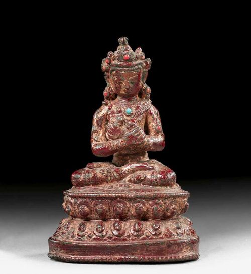 VAJRADHARA.Nepal, 15th century. H 8 cm. Dark copper bronze with remains of lacquer gilding and inlays of small glass stones. Closed.