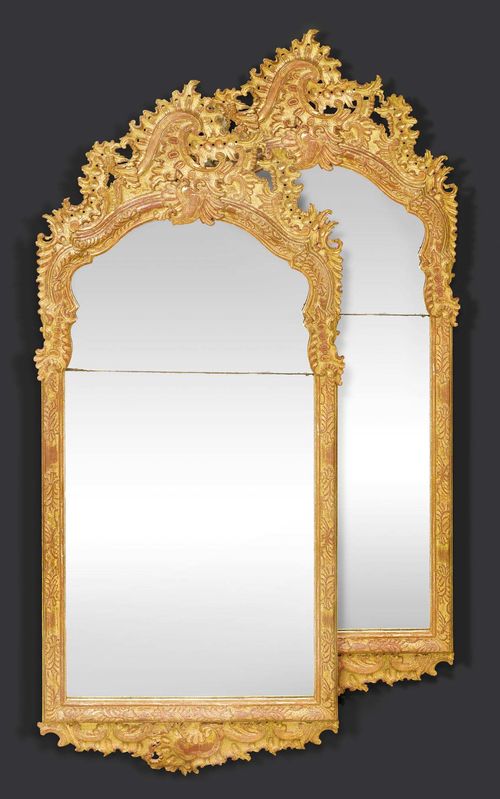 PAIR OF IMPORTANT MIRRORS, Louis XV, Lohr circa 1730/40. Pierced and exceptionally finely carved gilt wood with cartouches, flowers, leaves and decorative frieze. The mirror plate in two parts. Some chips. H 170 cm, W 75 cm. Provenance: - Fischer-Boehler, Munich. - Private collection, Germany. One of the mirrors offered here is illustrated in: G. Child, World mirrors 1650-1900, London 1990; p. 229 (described as Frankfurt Mirror circa 1750).