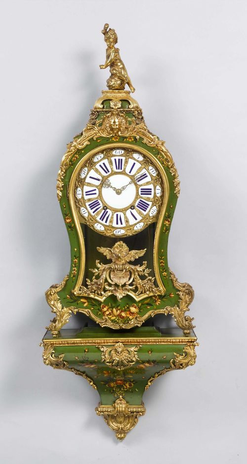 PAINTED PENDULE ON BASE,Regency style, France. Wood, painted green and decorated with flowers. Bronze mounts designed as volutes, eagle, mask and a putto. Bronze dial with enamel cartouches. Movement with anchor escapement striking the 1/2-hour on bell, repeater on demand. H 123 cm.