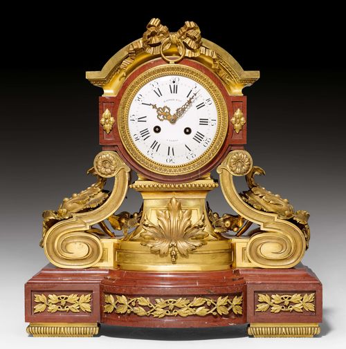 MANTEL CLOCK,Napoleon III, the dial signed RAINGO FRÈRES À PARIS (Raingo Frères, active ca. 1829-1865). Red marble and gilt bronze. Decorated with acanthus leaves, leaf garlands, volutes and bow. Paris escapement striking the 1/2-hour on bell. H 52 cm.