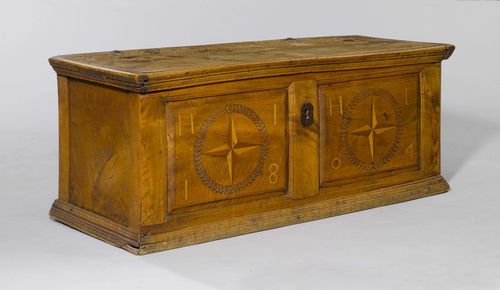 CARVED AND INLAID CHEST,late Baroque, from the Alpine region, dated 1804 and monogrammed HIHL. Walnut inlaid with stars in round reserves and carved with meander band. Rectangular body with hinged cover. Iron lock (defective). 125x47x50 cm.