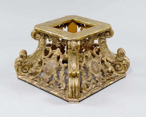 CARVED BASE,late Baroque, Italy, 19th century. Wood, pierced and carved with leaf volutes and cartouches and gilt. 80x80x51 cm. Can be used as the base for a coffee table. Losses, requires restoration.