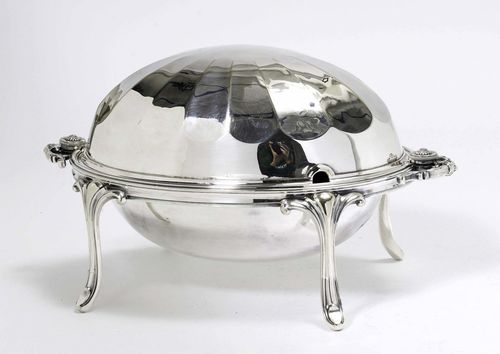 VEGETABLE POT WITH LID,silver-plated. Oval shape on four retracted legs. With a smooth and open-worked insert. Facetted lid, handles on both sides. H 13 and 23 cm.