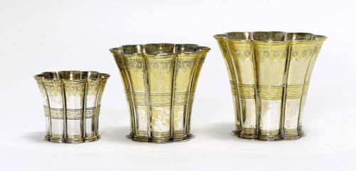 3 SILVER-GILT BEAKERS,Copenhagen. Maker's mark: A. Michelsen. 20th century. Blossom-shaped, tapered. With ornamental bands all around.  H (large) 10 cm, (medium) 8.5 cm, (small) 6 cm. D (large) 10.8 cm, (medium) 9.6 cm, (small) 7.2 cm. Total weight: 540 g.