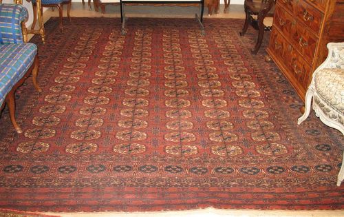 TEKKE BOCHARA old.Rust coloured ground with six gul rows, slight wear, 345x290 cm.