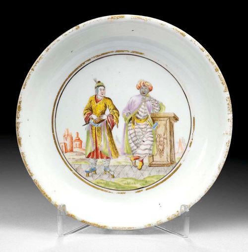 RARE SAUCER WITH HAUSMALER DECORATION, Meissen, circa 1730. Painting 2nd half of the 18th century.Painted with two Orientals in lavish garments in a landscape. Set in a double ring border in gold and Schwarzlot, the edge gilded. incised mark / in base ring. D 13.3cm. Gilding somewhat rubbed. Provenance: from a Swiss private collection.