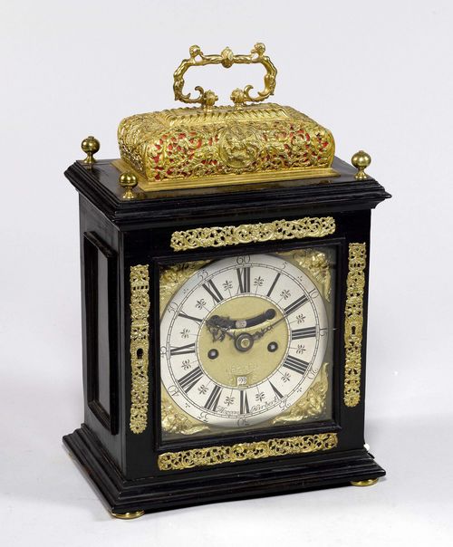 BRACKET CLOCK WITH CARILLON AND DATE,England, 18th century. The movement and dial signed MORGAN HARBERT LONDON. Rectangular case in black-painted wood, glazed on all sides, retracted top. Decorated with pierced brass mounts. Brass fronton with silver-plated chapter ring, framed by applied angel heads. Date window, visible pendulum. Movement with main spring, engraved plate, verge escapement, and striking the hour on bell. Repetition on demand, on 6 bells. 26x17x36 cm.