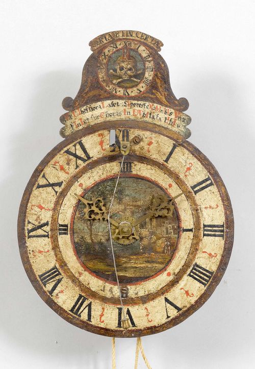 IRON WALL CLOCK WITH FRONT PENDULUM,Baroque, probably Switzerland, 18th century. Closed steel case, the dial painted and inscribed. Iron movement with brass cog wheels. Verge escapement, striking the 1/2-hour on bell. Alarm on bell. 24x10x32 cm. Requires servicing.